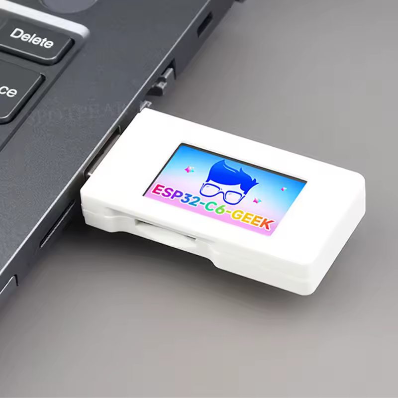 The Waveshare ESP32-C6-GEEK: a small white USB dongle with a colour screen, plugged into the side of a laptop.